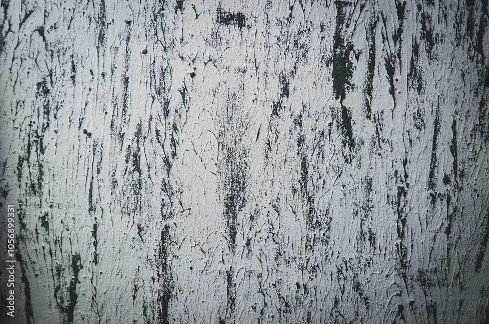 A wall with a lot of scratches and marks on it. The wall is gray and has a rough texture. A wall with a lot of scratches and marks on it. The wall is gray and has a rough texture.