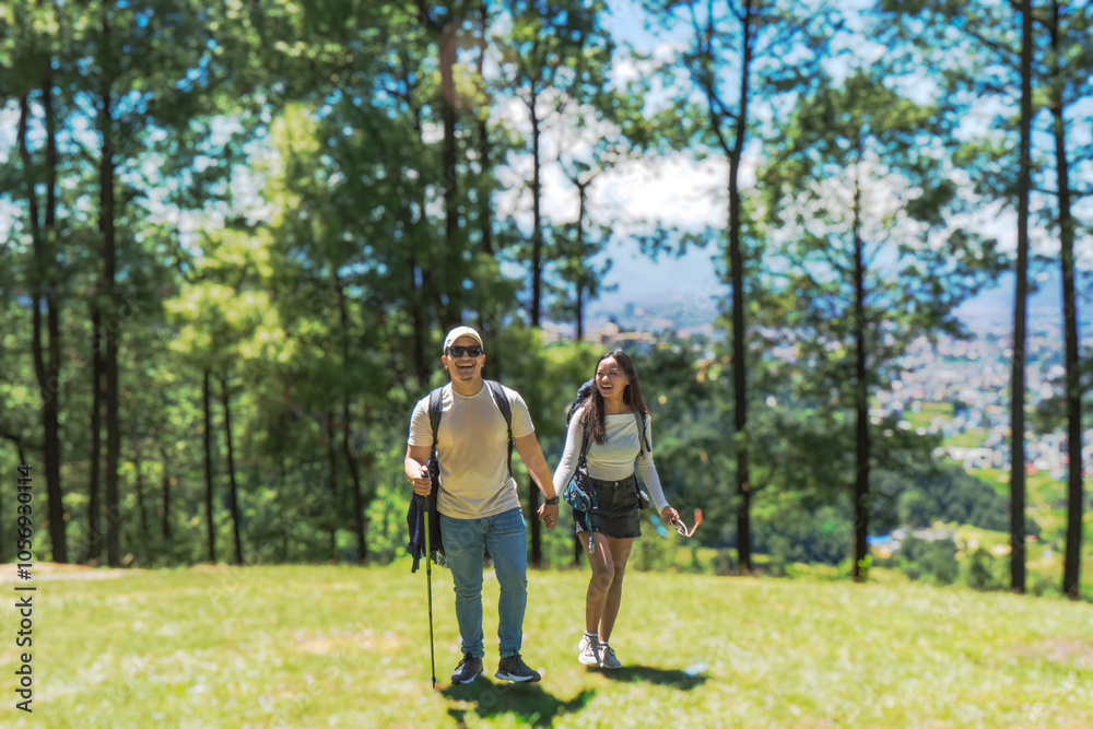 Young Happy Couple Hiking in the Nature Forest Loking direction and enjoying national park trekking Young Happy Couple Hiking in the Nature Forest Loking direction and enjoying national park trekking