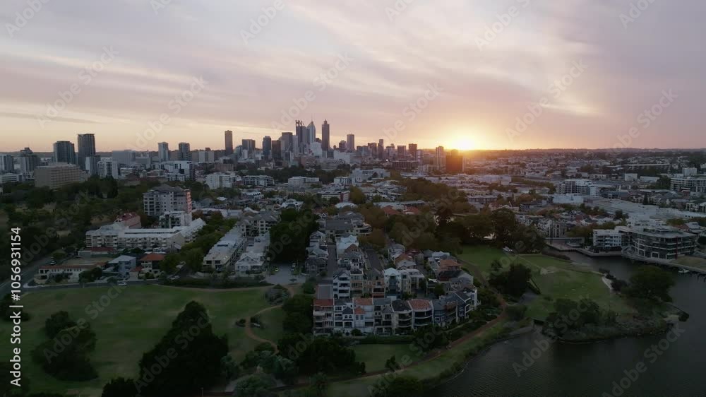 Perth city skyline with sun setting just on horizon Perth city skyline with sun setting just on horizon