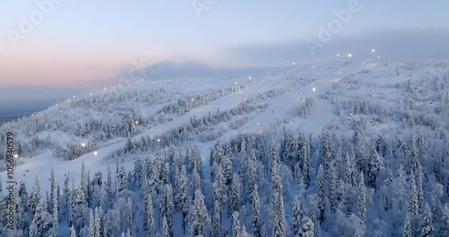 Panoramic drone shot circling the slopes of Sallatunturi, sunrise in Finland photo