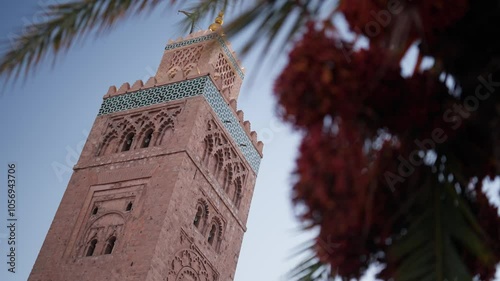 Close Slowmotion of arabian pray tower in marakkesh in morocco with palm tree photo