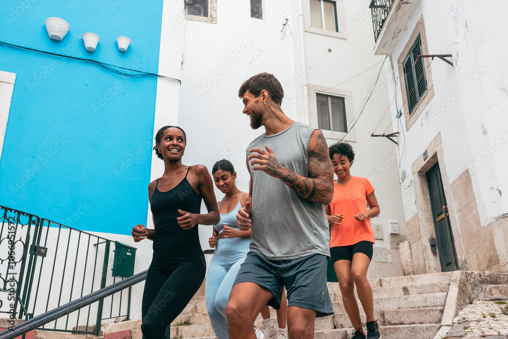 Obraz premium Athletes running up stairs in urban setting, promoting healthy lifestyle and fitness
