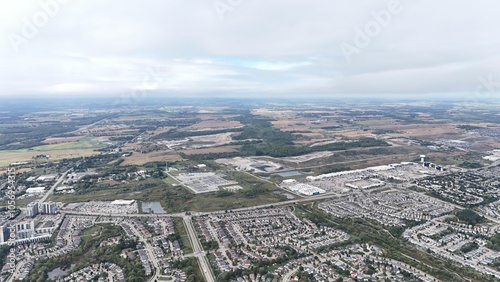 Aerial view of suburban landscape and fields.