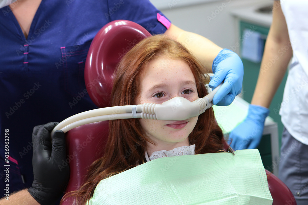 Little girl is injected with an inhalation sedation during dental ...