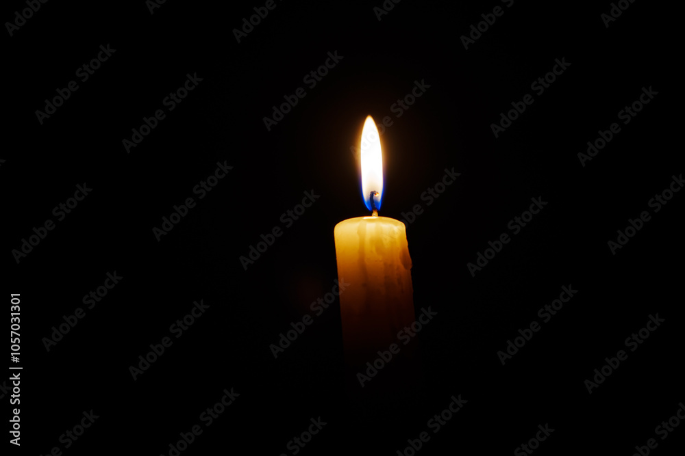 Close-up single candle burning on dark black background, candle fire flame light. Close-up single candle burning on dark black background, candle fire flame light.