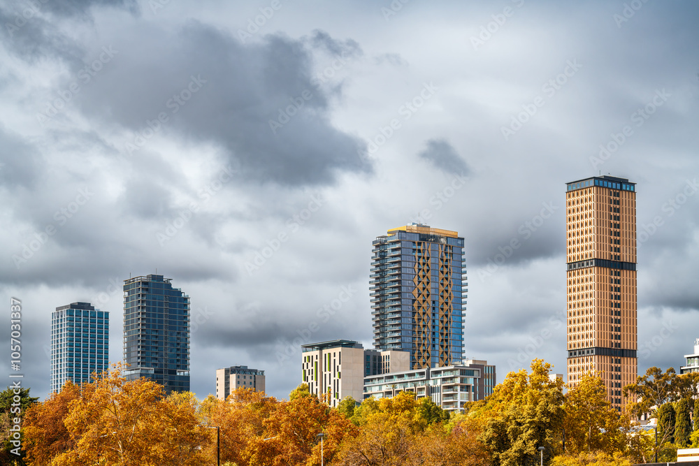 Obraz premium High rise hotels and student accommodation and apartment buildings in Adelaide City viewed from the Riverbank during autumn season