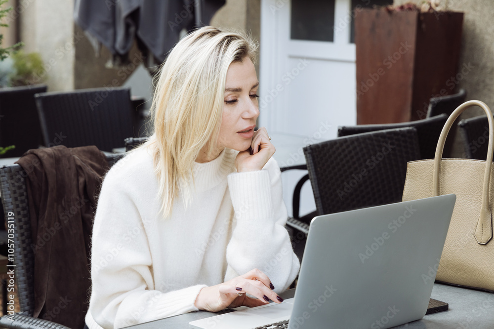 Beautiful young woman using laptop in a cafe Beautiful young woman using laptop in a cafe