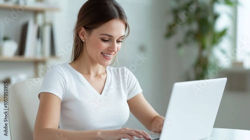 A white American mother with a bright smile is focused on her laptop in a spacious, elegantly designed study. Sunlight fills the room, creating a cheerful atmosphere