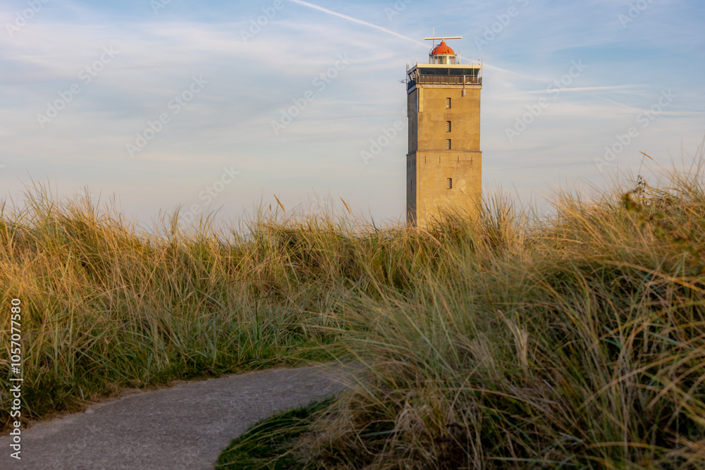 The Vuurtoren Brandaris (Lighthouse) under blue sky and white clouds, The Dutch Wadden Sea island Terschelling, A municipality and an island in the northern, Friesland, West-Terschelling, Netherlands. The Vuurtoren Brandaris (Lighthouse) under blue sky and white clouds, The Dutch Wadden Sea island Terschelling, A municipality and an island in the northern, Friesland, West-Terschelling, Netherlands.