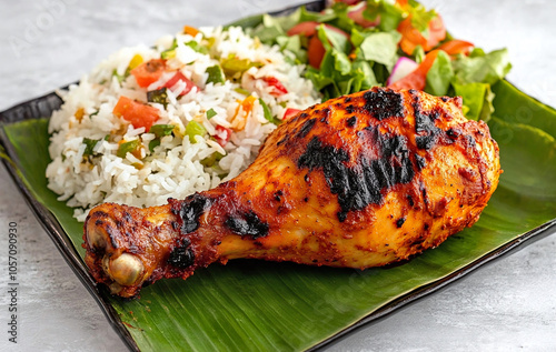 Tandoori chicken leg with biriyani rice served on banana leaf. photo