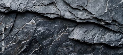 A monochrome photograph showcasing a large heap of black rocks