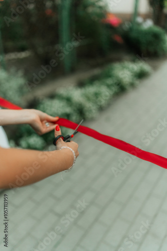 scissors cutting red ribbon