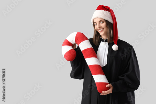 Female judge in Santa hat w...