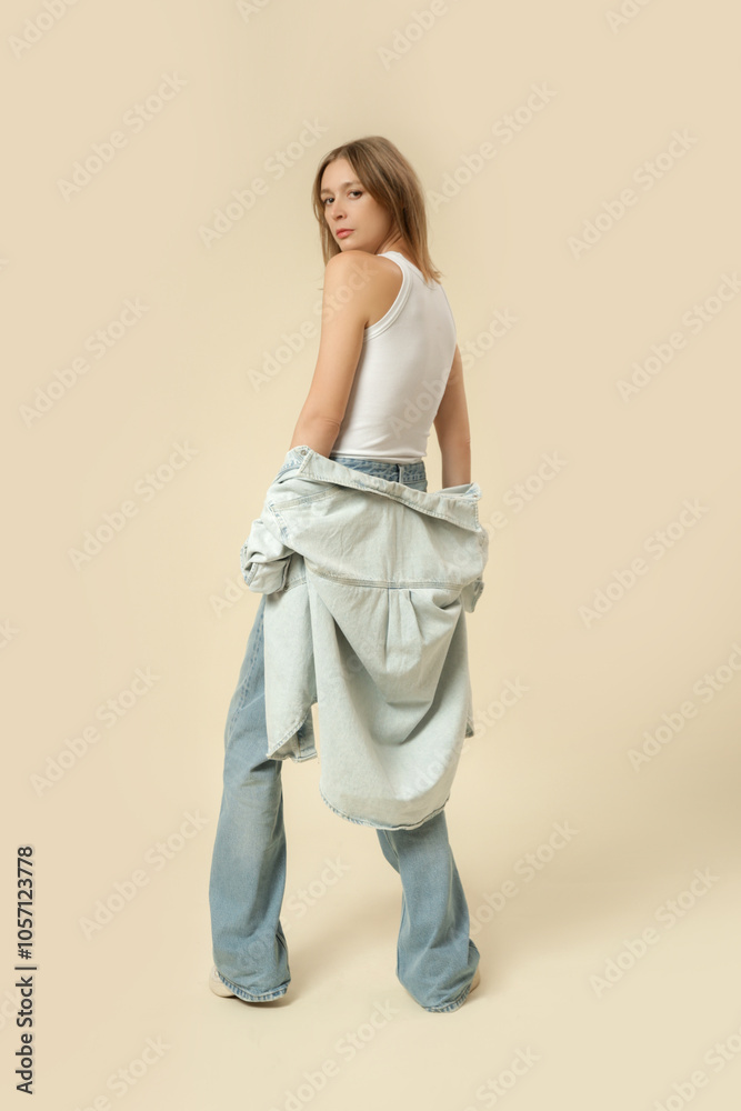 Serie of studio photos of woman in modern casual outfit, blue jeans, white tank top and denim overshirt. Serie of studio photos of woman in modern casual outfit, blue jeans, white tank top and denim overshirt.