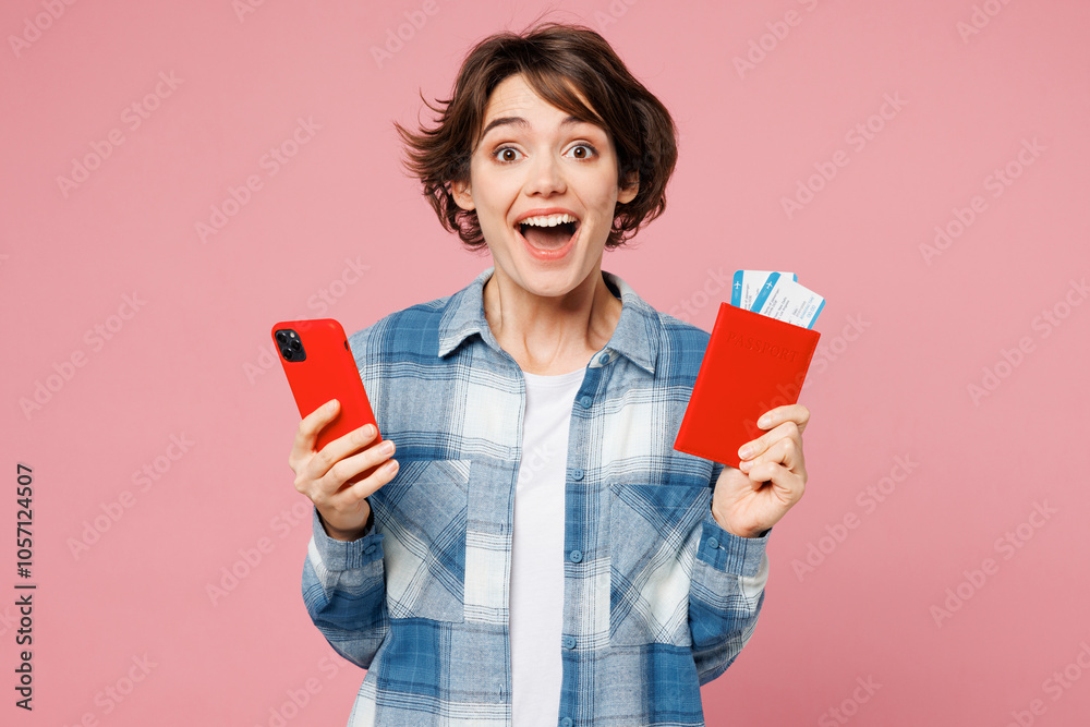 Traveler woman in blue casual clothes hold passport ticket, mobile cell phone isolated on plain pink background. Tourist travel abroad in free spare time rest getaway Air flight trip journey concept Traveler woman in blue casual clothes hold passport ticket, mobile cell phone isolated on plain pink background. Tourist travel abroad in free spare time rest getaway Air flight trip journey concept