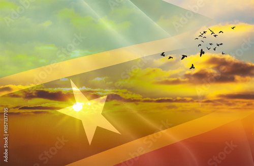 Waving the flag of Saint Kitts and Nevis against the background of a sunset or sunrise. Saint Kitts and Nevis flag for Independence Day. The symbol of the state on wavy fabric. photo