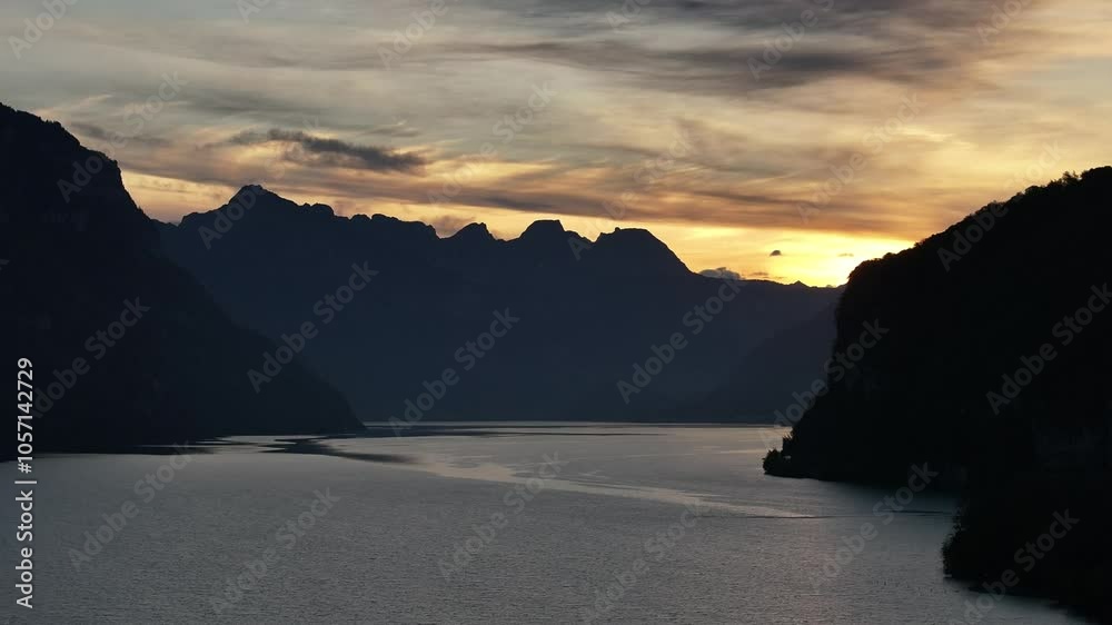 Aerial view over Switzerland's Lake Walensee at evening, showcasing calm waters and peaceful, untouched natural scenery. A serene landscape perfect for capturing nature's tranquility. Aerial view over Switzerland's Lake Walensee at evening, showcasing calm waters and peaceful, untouched natural scenery. A serene landscape perfect for capturing nature's tranquility.