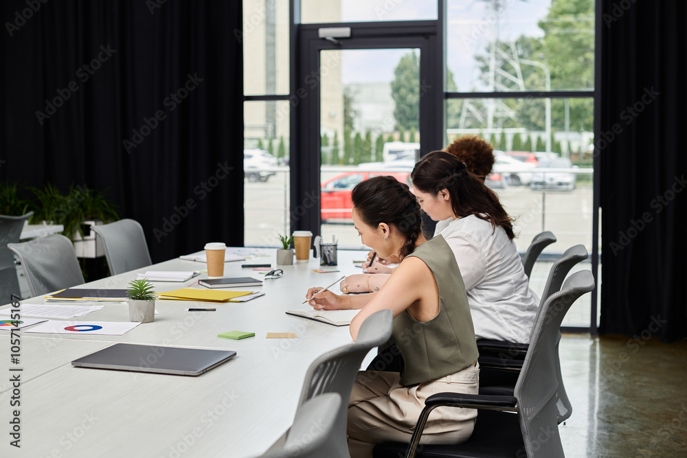 Elegant women engage in focused discussions and brainstorming at a stylish office table. Elegant women engage in focused discussions and brainstorming at a stylish office table.