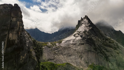 the rocks in the form of a parabola are shrouded in white clouds