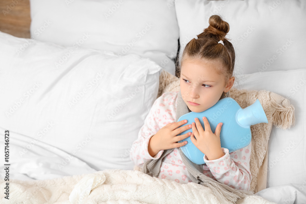 Sick little girl with sore throat and hot water bottle lying in bedroom Sick little girl with sore throat and hot water bottle lying in bedroom