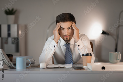 Stressed businessman sittin...