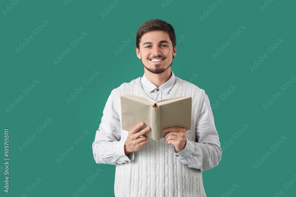 Young man reading book on green background Young man reading book on green background