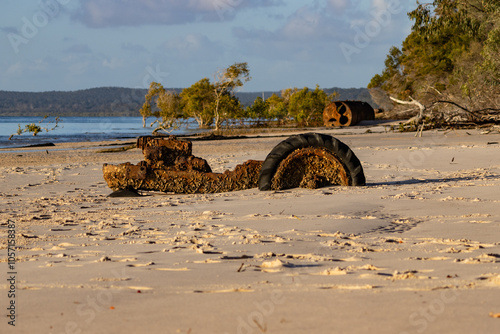 rusty machinery buried on sandy beach, K'gari, Fraser Island, Queensland Australia