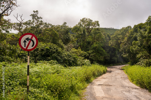 overtaking prohibited sign board. No overtaking sign board on curve jungle road