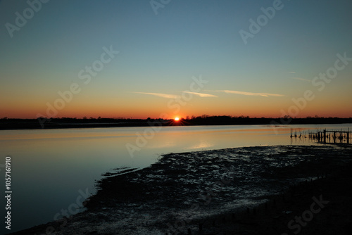 tramonto sulla foce dell'isonzo con cielo sereno photo