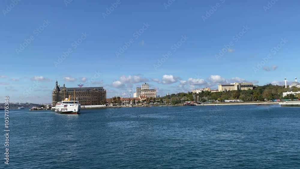 Kadıköy, Istanbul - Turkey, 24 October 2024: Eminönü ferry approaches Kadıköy pier, view of Haydarpaşa behind. A passenger ferry on the Bosphorus. Kadıköy, Istanbul - Turkey, 24 October 2024: Eminönü ferry approaches Kadıköy pier, view of Haydarpaşa behind. A passenger ferry on the Bosphorus.