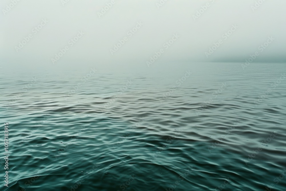 Obraz premium A serene view of rippling water in a misty ambiance, showcasing calm and an endless horizon that evokes a profound sense of tranquility.