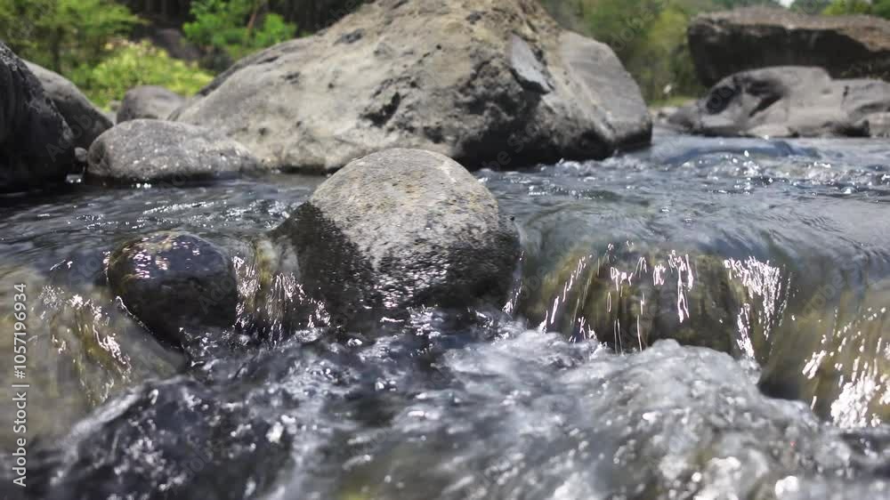 Fresh water flowing over stones. Small rapids of mountain stream Fresh water flowing over stones. Small rapids of mountain stream