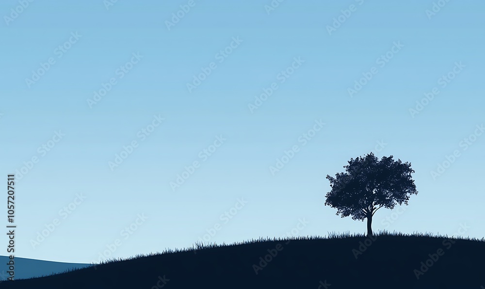 Fototapeta premium A solitary tree on a hill under a clear blue sky, evoking tranquility and nature's beauty.
