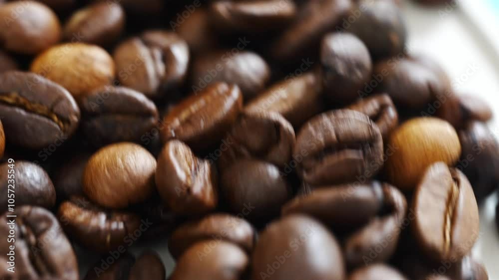 rotating roasted beans of natural coffee. raw materials for coffee shops, coffee machines. rotating roasted beans of natural coffee. raw materials for coffee shops, coffee machines.