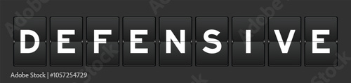 Black color analog flip board with word defensive on gray background