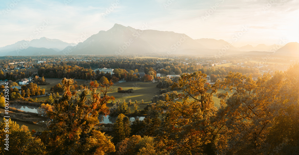 Beautiful panoramic view of yellow fall scenery in Salzburg with Untersberg mountain in golden evening light at sunset, Austria