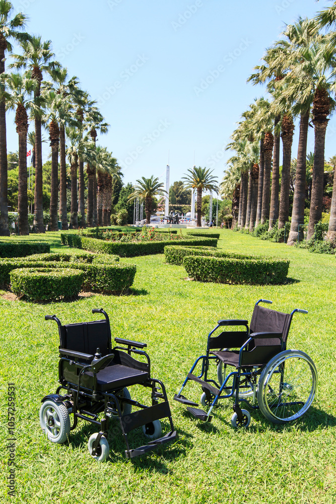 Empty wheelchair over green grass Empty wheelchair over green grass
