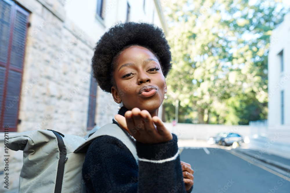Joyful Young Woman Blowing a Kiss on a Sunlit City Street with a Stylish Backpack Joyful Young Woman Blowing a Kiss on a Sunlit City Street with a Stylish Backpack