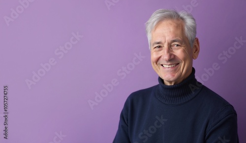 Senior man with cheerful smile posing against purple background with copy space