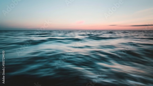 Blurred motion of sunset hues over ocean's edge