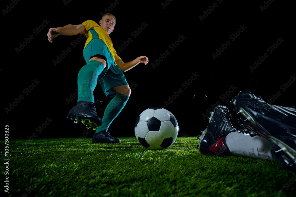 Close-up of soccer ball with two players converging in dynamic moment on field. Bombardier opponent of goalkeeper. Concept of sport event, championship, motion, match, energetic game. Ad Close-up of soccer ball with two players converging in dynamic moment on field. Bombardier opponent of goalkeeper. Concept of sport event, championship, motion, match, energetic game. Ad