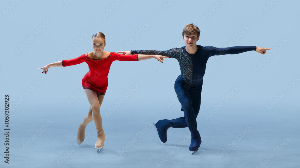 Obraz premium Confident and synchronized pose from young figure skating duo, highlighting their competitive spirit and precision. Concept of winter sport, elegance and grace, championship. Ad