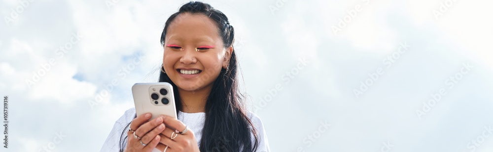 A stylish young Asian girl embraces youth culture, smiling widely as she connects with friends outdoors. A stylish young Asian girl embraces youth culture, smiling widely as she connects with friends outdoors.
