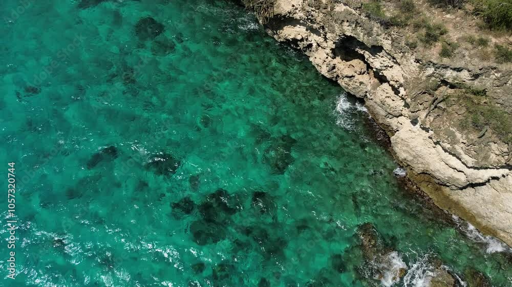 Beautiful Caribbean sea beach with on the coast with deep blue ocean water and an exotic beach with white sand on the sunny tropical island of Curacao - aerial drone flight shot Beautiful Caribbean sea beach with on the coast with deep blue ocean water and an exotic beach with white sand on the sunny tropical island of Curacao - aerial drone flight shot