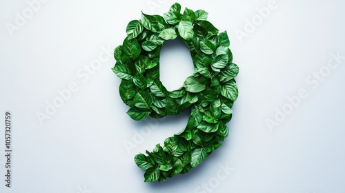 Alphabet formed by green leaves shaped like the number nine representing a nature themed concept photo