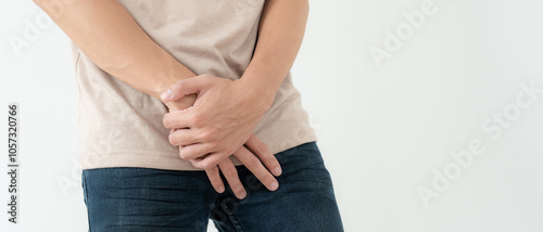 Cuadro en lienzo Man hold hand in front of private parts feeling discomfort from disease and inflammation
