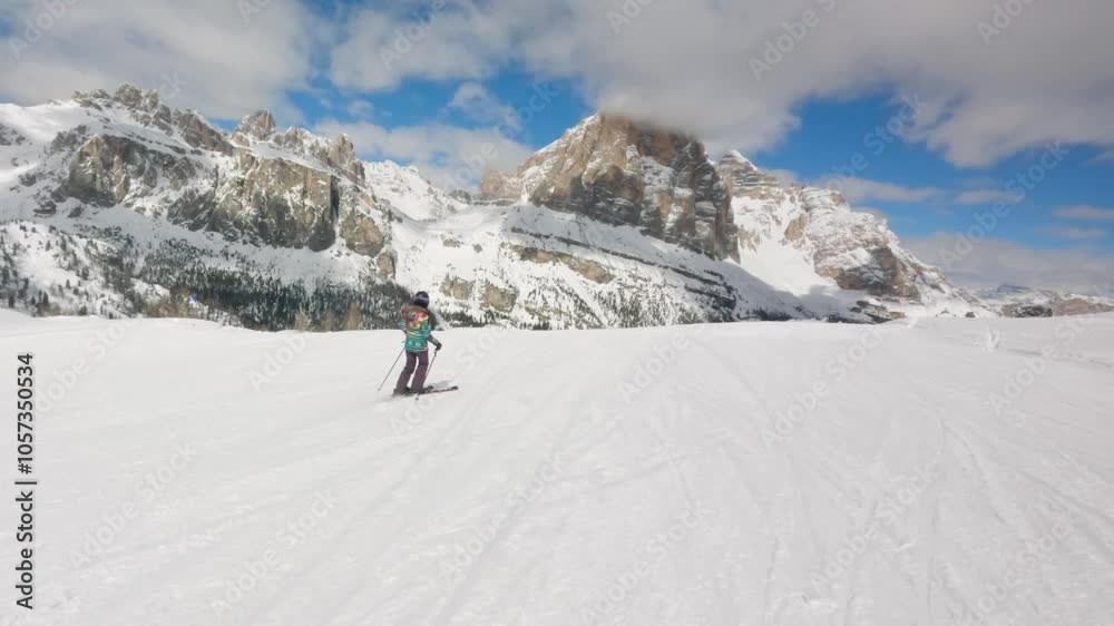 Woman skier ski in Cortina D'Ampezzo Ski Resort Dolomites Italian Alps Woman skier ski in Cortina D'Ampezzo Ski Resort Dolomites Italian Alps