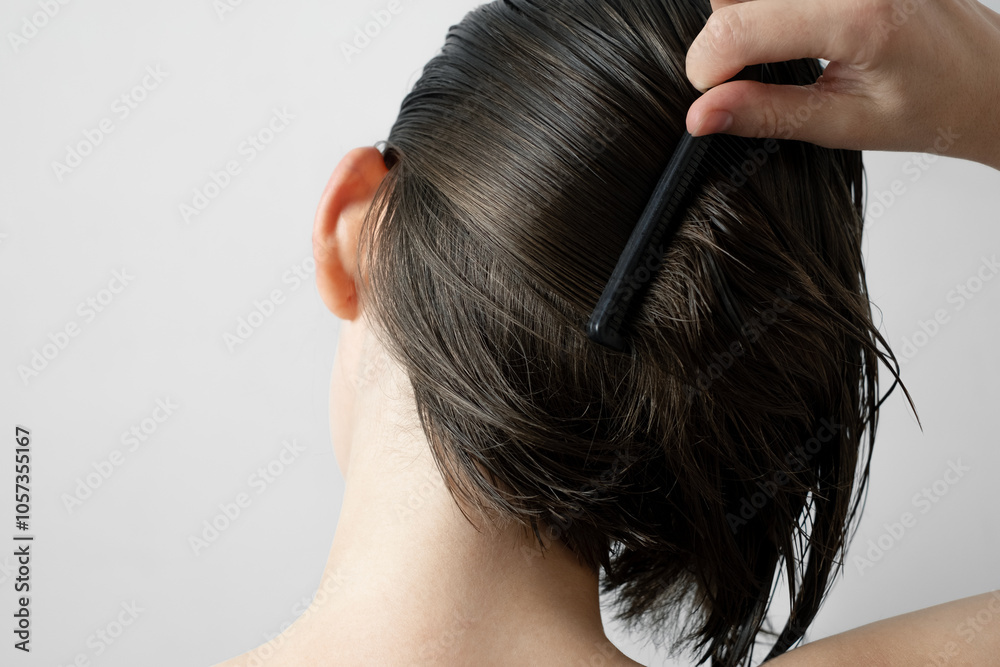 Naklejka premium Brushing wet hair with comb for healthy care