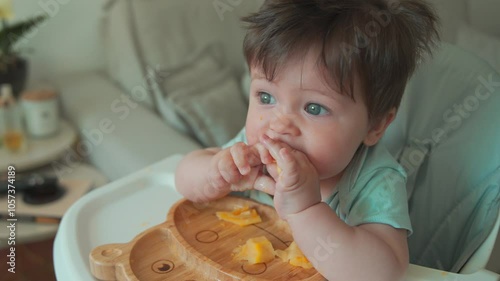 Baby boy eating at home