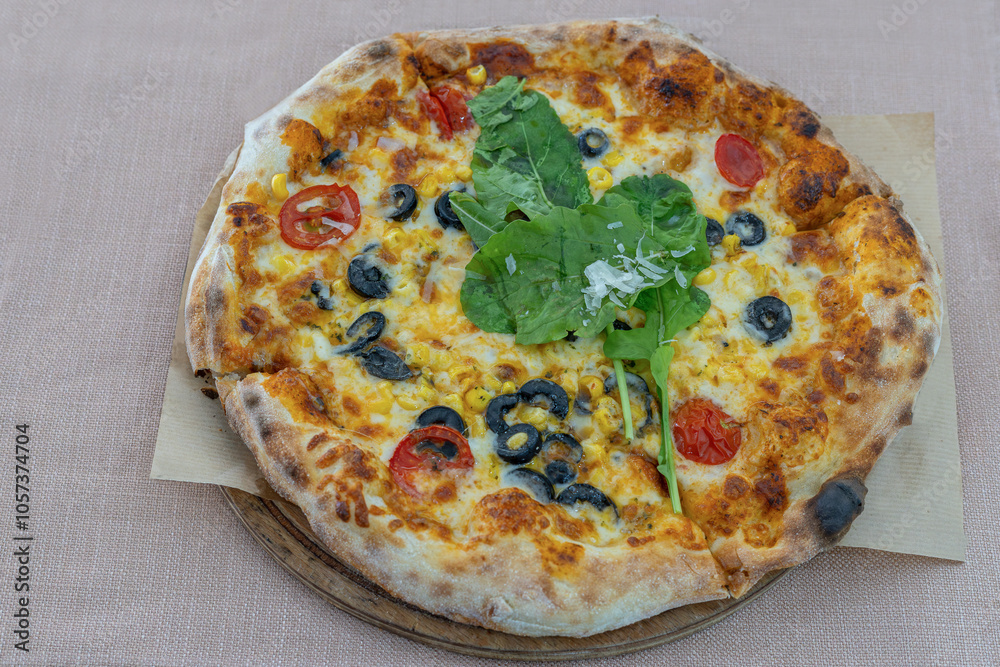 Four seasons pizza. Tomatoes, grated mozzarella, tomato sauce, corn kernels, black olive slices, arugula.